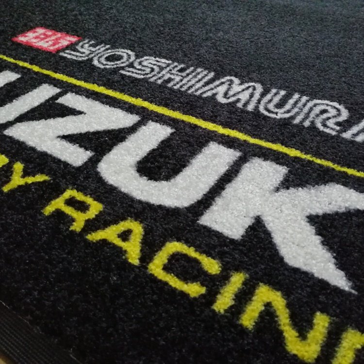 3D embossed tufted surface of SHYNGO doormat for effective dirt scraping and mud removal.